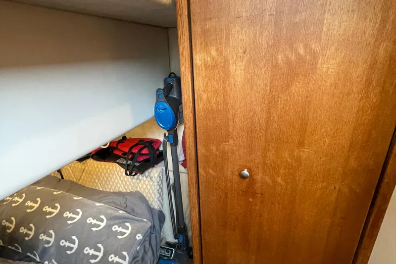  Yacht Photos Pics 1999 Bayliner 3988 Motoryacht cabin interior with wooden paneling and storage area.