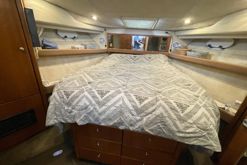  Yacht Photos Pics 1999 Bayliner 3988 Motoryacht cabin with bed, storage, and cozy lighting.