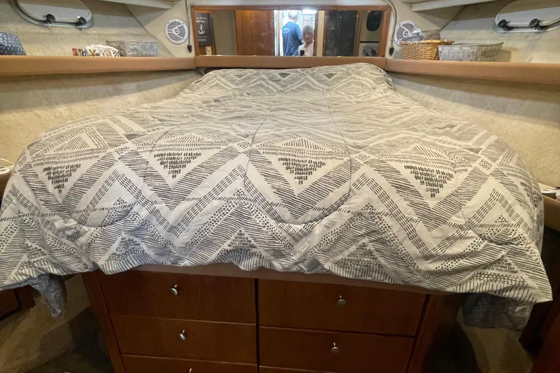  Yacht Photos Pics Cozy bedroom interior of 1999 Bayliner 3988 Motoryacht with patterned bedding.