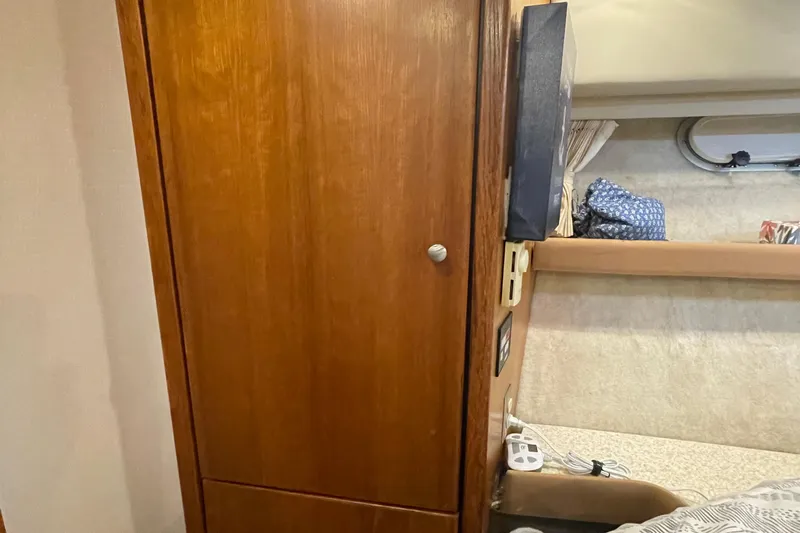  Yacht Photos Pics Interior of 1999 Bayliner 3988 Motoryacht with wooden cabinet and cozy sleeping area.