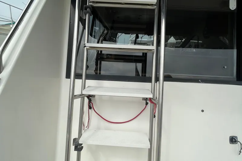  Yacht Photos Pics Stainless steel ladder on 1999 Bayliner 3988 Motoryacht, leading to upper deck.
