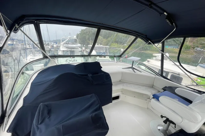  Yacht Photos Pics 1999 Bayliner 3988 Motoryacht interior with covered seating and marina view.
