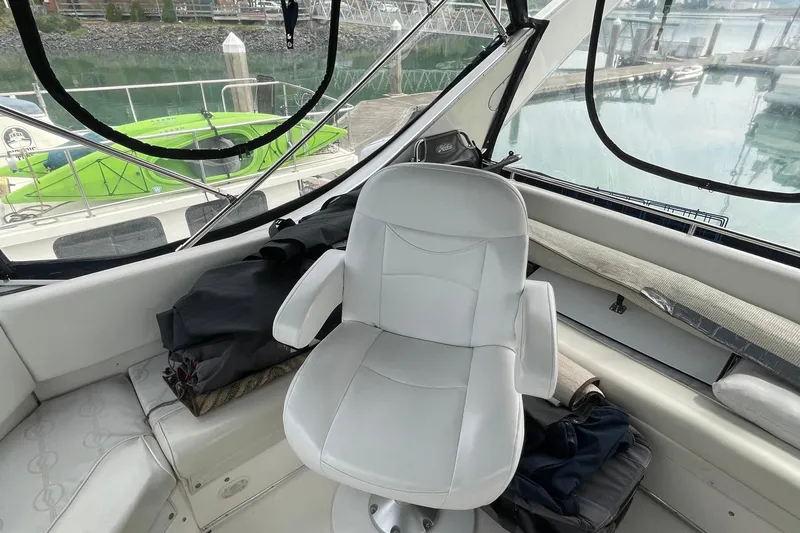  Yacht Photos Pics 1999 Bayliner 3988 Motoryacht interior with white captain's chair and marina view.