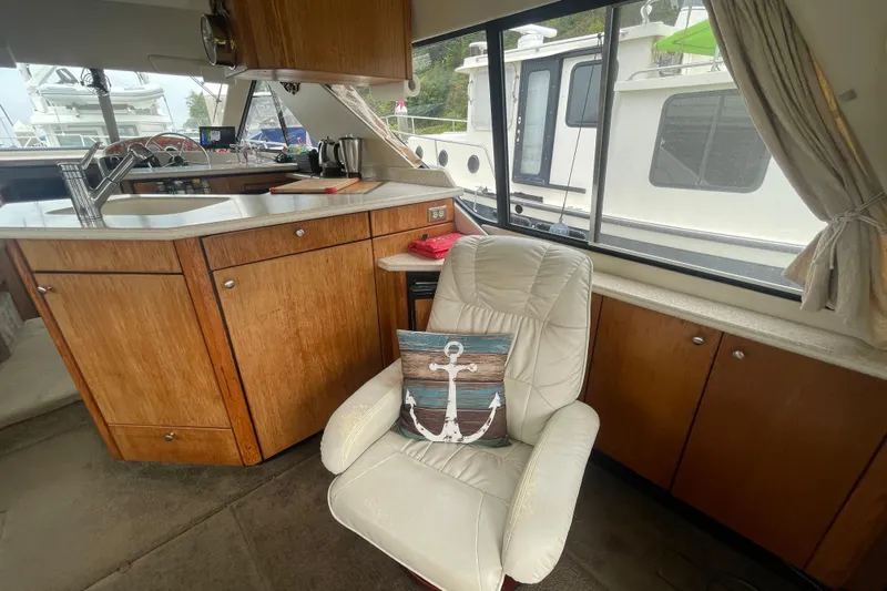  Yacht Photos Pics 1999 Bayliner 3988 Motoryacht interior with kitchen and comfortable seating area.