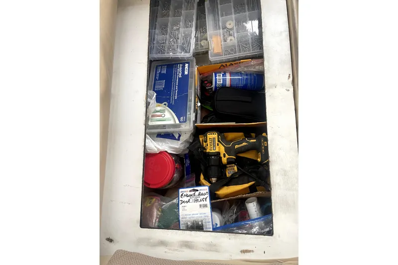  Yacht Photos Pics Storage compartment on a 1999 Bayliner 3988 Motoryacht filled with tools and supplies.