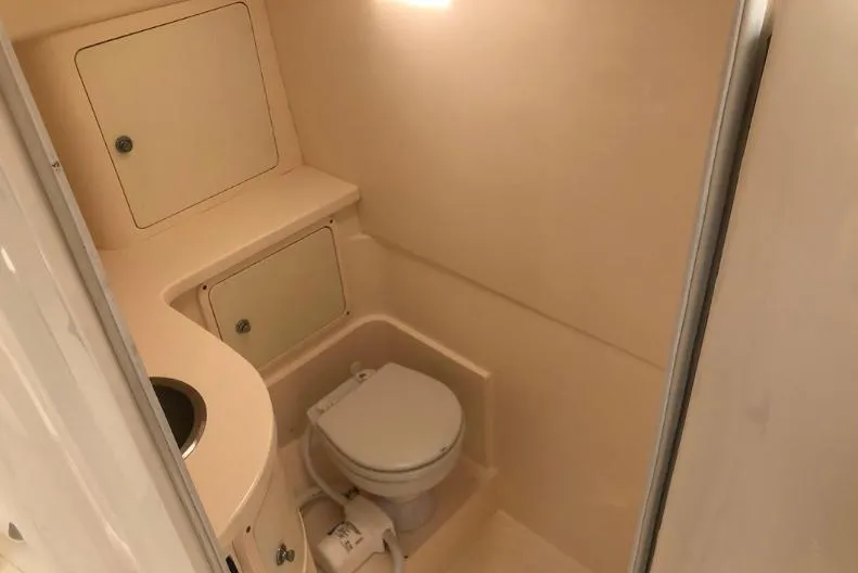 Soggy Dollars Yacht Photos Pics 2007 Intrepid 35 Walkaround boat bathroom with toilet and storage compartments.