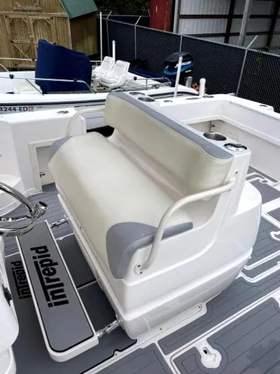 Soggy Dollars Yacht Photos Pics 2007 Intrepid 35 Walkaround boat interior with cushioned seating and branded flooring.