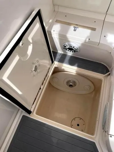 Soggy Dollars Yacht Photos Pics 2007 Intrepid 35 Walkaround storage compartment with open hatch and speaker.