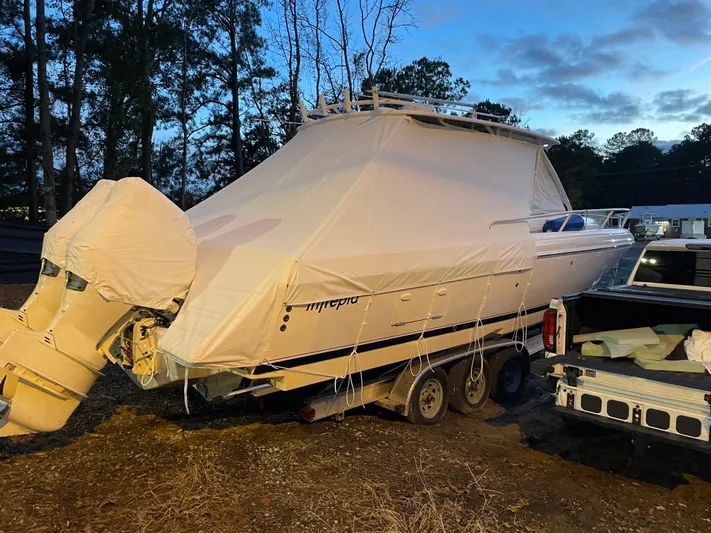 Soggy Dollars Yacht Photos Pics 2007 Intrepid 35 Walkaround boat covered and parked on a trailer outdoors.