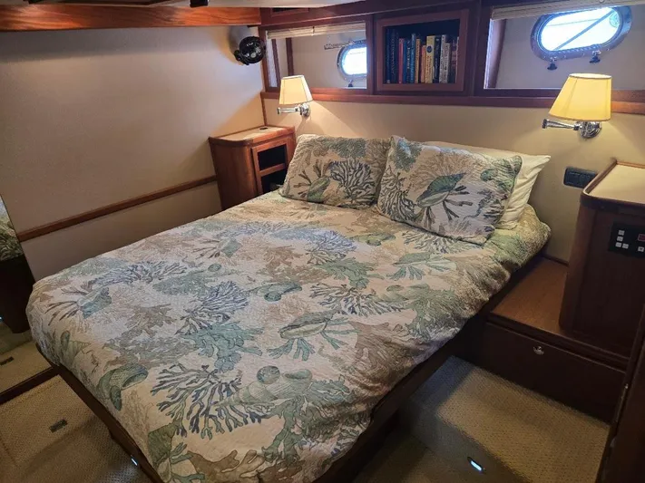 Chinook Yacht Photos Pics Cozy bedroom in 2010 American Tug 49 Limited with floral bedding and warm lighting.