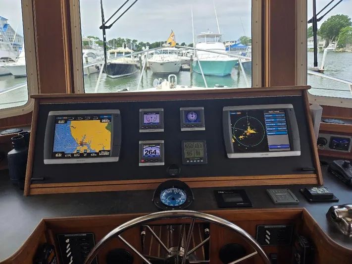 Chinook Yacht Photos Pics Cockpit of 2010 American Tug 49 Limited with navigation screens and marina view.