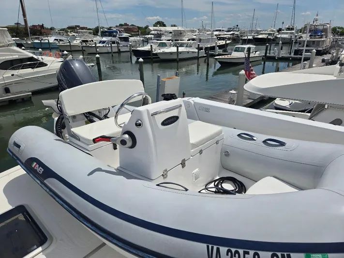 Chinook Yacht Photos Pics Inflatable boat docked at marina, surrounded by yachts; American Tug 49 Limited, 2010 model.