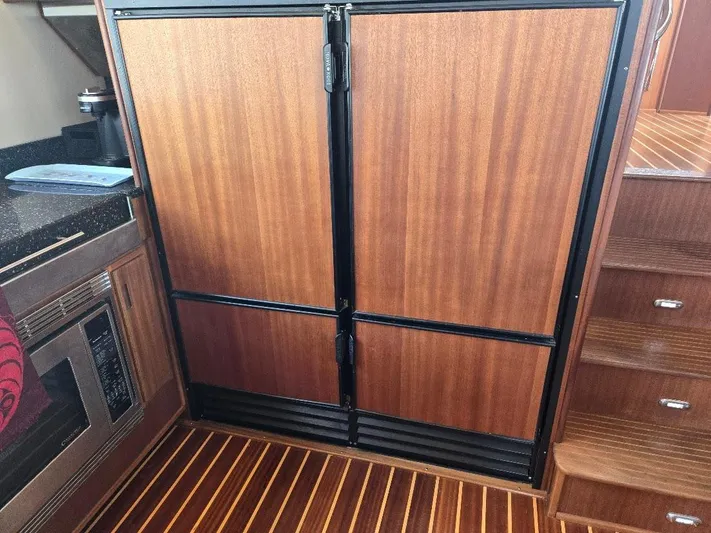Chinook Yacht Photos Pics Wood-paneled refrigerator in 2010 American Tug 49 Limited yacht kitchen.