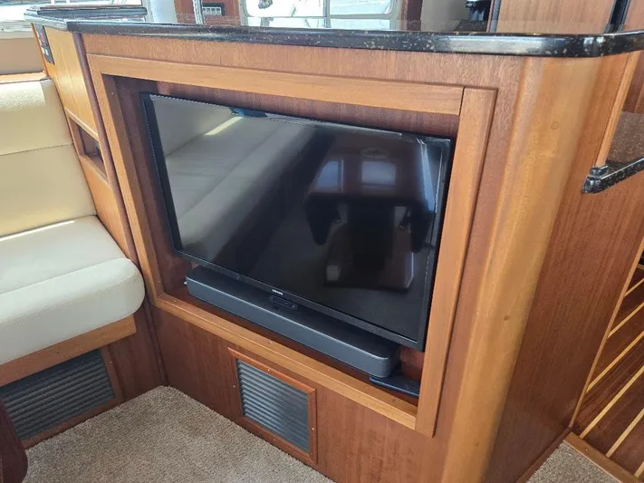 Chinook Yacht Photos Pics Flat-screen TV in 2010 American Tug 49 Limited yacht interior with wood paneling.