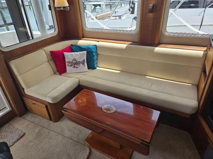 Chinook Yacht Photos Pics Luxurious interior of 2010 American Tug 49 Limited with beige seating and wooden table.