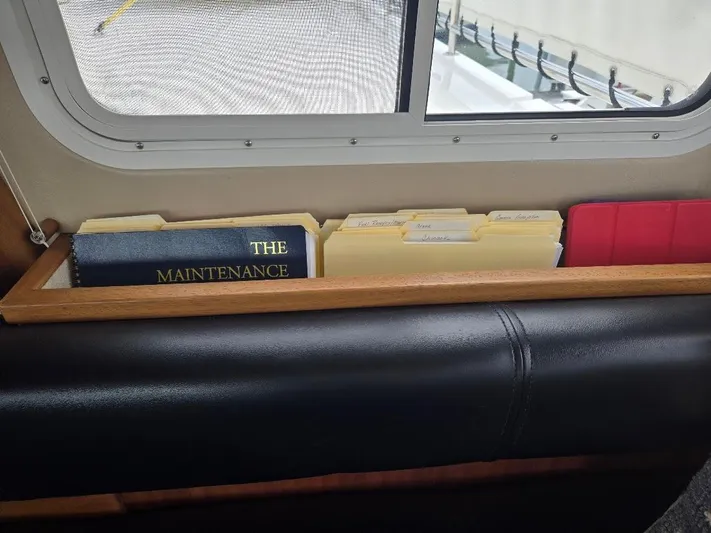 Chinook Yacht Photos Pics Maintenance book and folders on American Tug 49 Limited, 2010 model, near window.