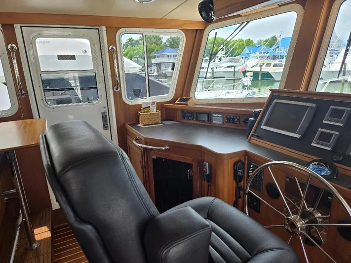 Chinook Yacht Photos Pics Interior of 2010 American Tug 49 Limited, featuring helm station and leather seating.