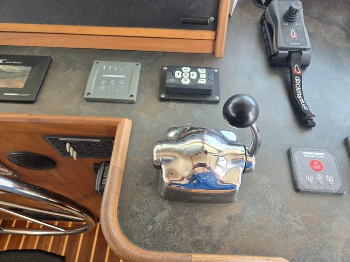 Chinook Yacht Photos Pics Control panel of a 2010 American Tug 49 Limited boat with throttle and navigation controls.