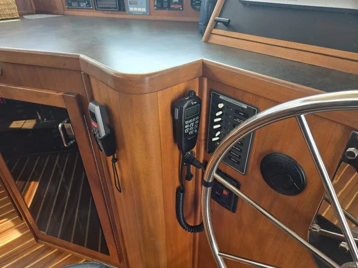 Chinook Yacht Photos Pics 2010 American Tug 49 Limited helm with wooden cabinetry and communication equipment.