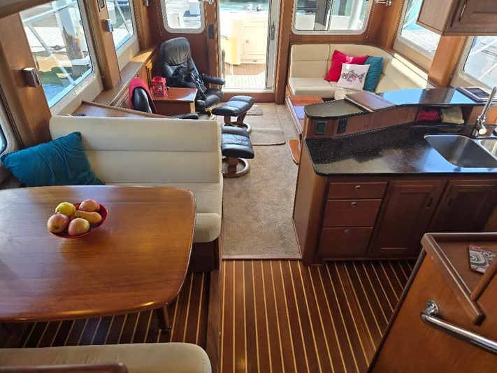 Chinook Yacht Photos Pics Interior of 2010 American Tug 49 Limited, featuring cozy seating and modern kitchen amenities.