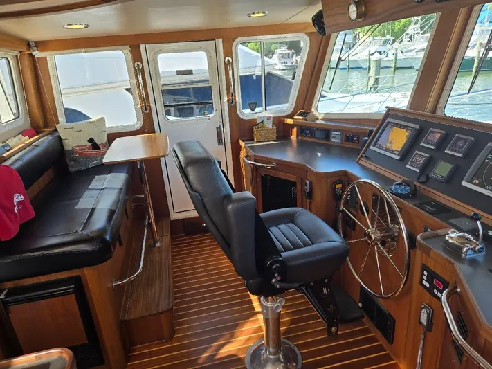 Chinook Yacht Photos Pics Pilothouse of 2010 American Tug 49 Limited with leather seating and navigation equipment.