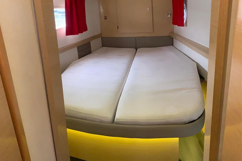 Freckled Parrot Yacht Photos Pics Interior cabin of 2015 Fountaine Pajot Helia 44 catamaran with double bed and red curtains.