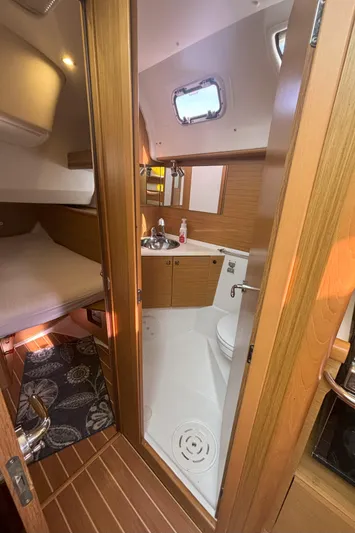  Yacht Photos Pics Interior of 2009 Jeanneau Sun Odyssey 44i yacht, featuring a compact bathroom and cozy cabin.