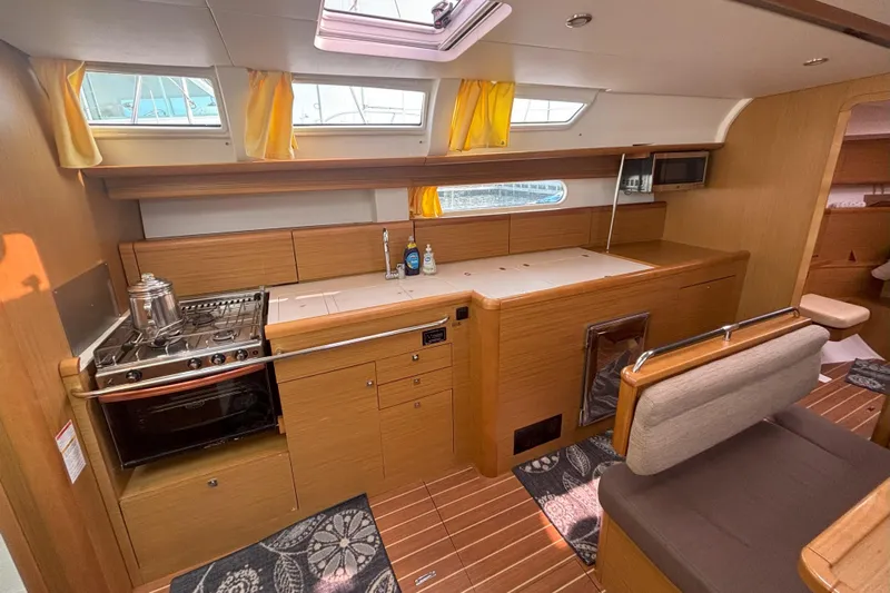  Yacht Photos Pics Interior of 2009 Jeanneau Sun Odyssey 44i yacht, featuring a modern kitchen and seating area.