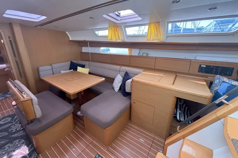  Yacht Photos Pics Interior of 2009 Jeanneau Sun Odyssey 44i sailboat with cozy seating and dining area.