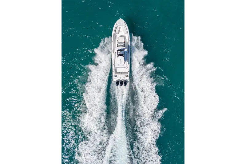 Papa Roach III Yacht Photos Pics Aerial view of 2025 Everglades 375 Center Console boat cruising on turquoise water.