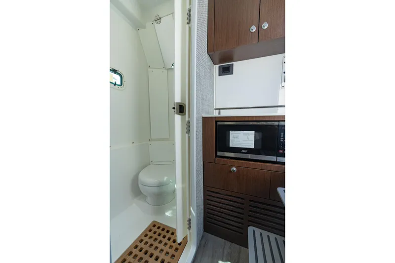 Papa Roach III Yacht Photos Pics 2025 Everglades 375 Center Console interior with modern bathroom and kitchenette.