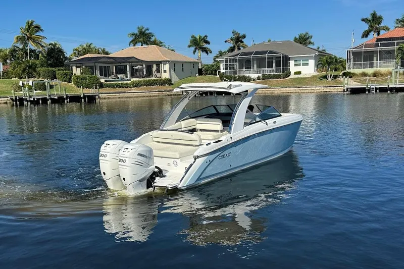  Yacht Photos Pics 2018 Cobalt 30SC boat cruising on a calm lake near waterfront homes.