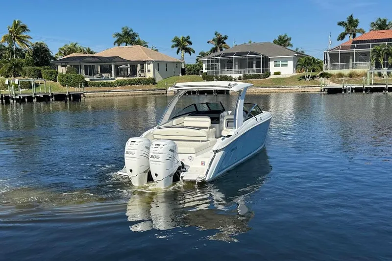  Yacht Photos Pics 2018 Cobalt 30SC boat with dual engines on a calm waterfront.
