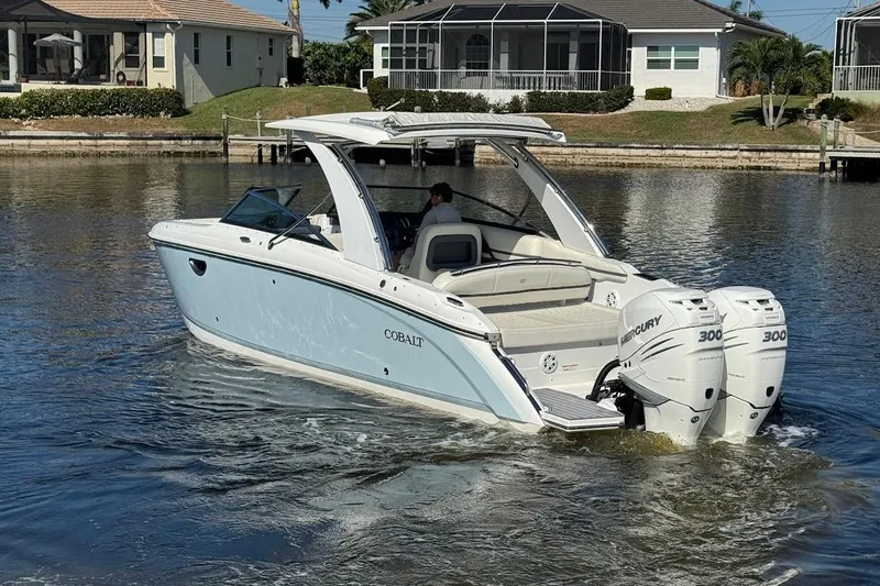  Yacht Photos Pics 2018 Cobalt 30SC boat with twin Mercury 300 engines on a calm waterway.