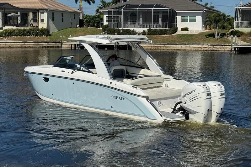  Yacht Photos Pics 2018 Cobalt 30SC boat with twin Mercury engines on a calm waterway.