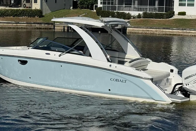  Yacht Photos Pics 2018 Cobalt 30SC boat cruising on a calm waterway, featuring sleek design and modern amenities.