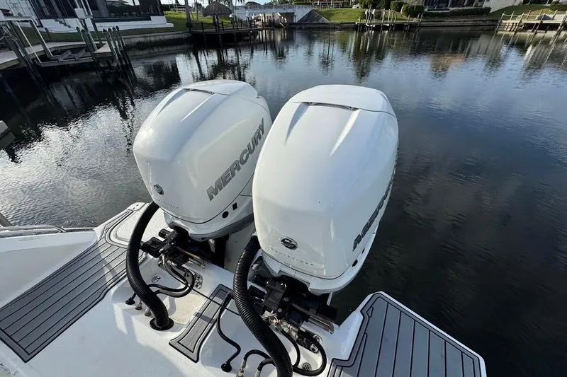  Yacht Photos Pics 2018 Cobalt 30SC boat with dual Mercury outboard engines on a calm waterway.