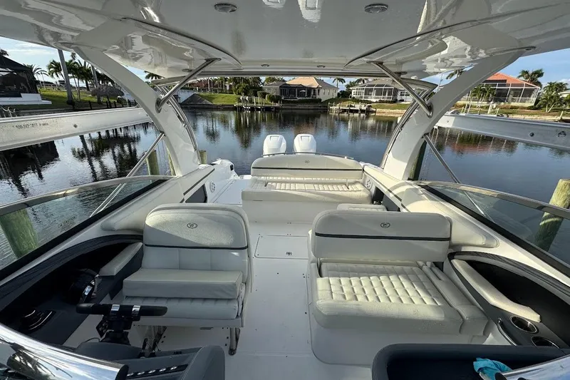  Yacht Photos Pics 2018 Cobalt 30SC boat interior with luxurious seating, docked by a serene waterfront.