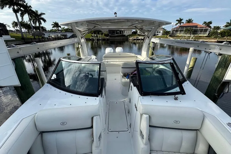  Yacht Photos Pics 2018 Cobalt 30SC boat with white interior, docked in a scenic waterfront setting.