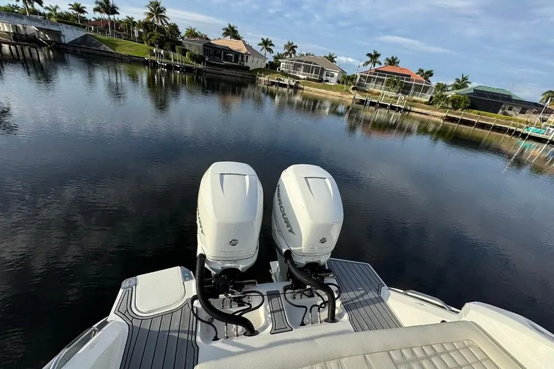  Yacht Photos Pics 2018 Cobalt 30SC boat with dual Mercury outboard engines on a calm waterfront.