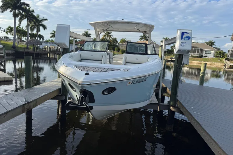  Yacht Photos Pics 2018 Cobalt 30SC boat docked in a scenic waterfront setting with palm trees.