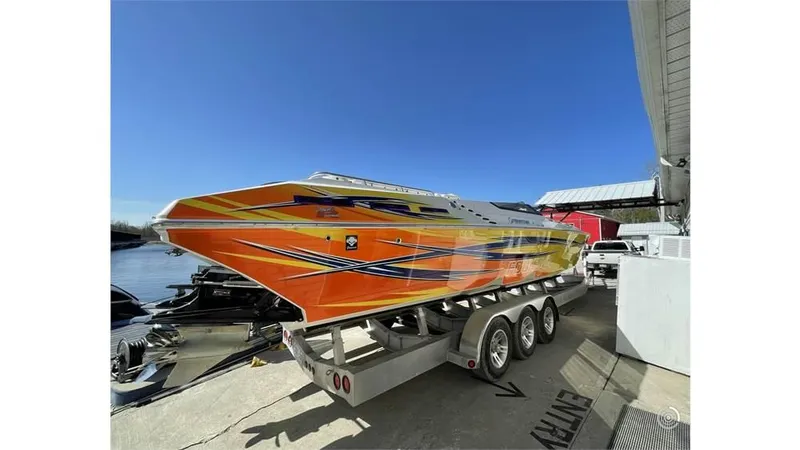  Yacht Photos Pics 2006 Fountain 42 speedboat with vibrant orange and yellow design on a trailer.
