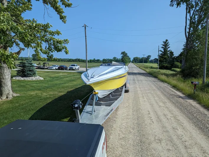 Yacht Photos Pics Yellow Fountain 42 boat on trailer, rural road, clear sky, 2006 model.