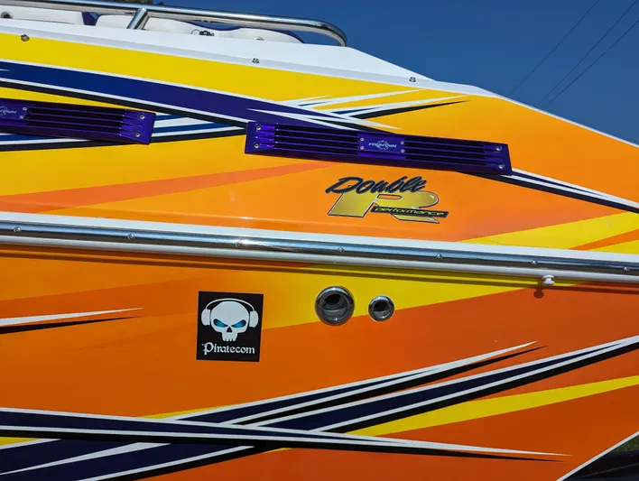  Yacht Photos Pics Colorful 2006 Fountain 42 boat with vibrant graphics and logo.