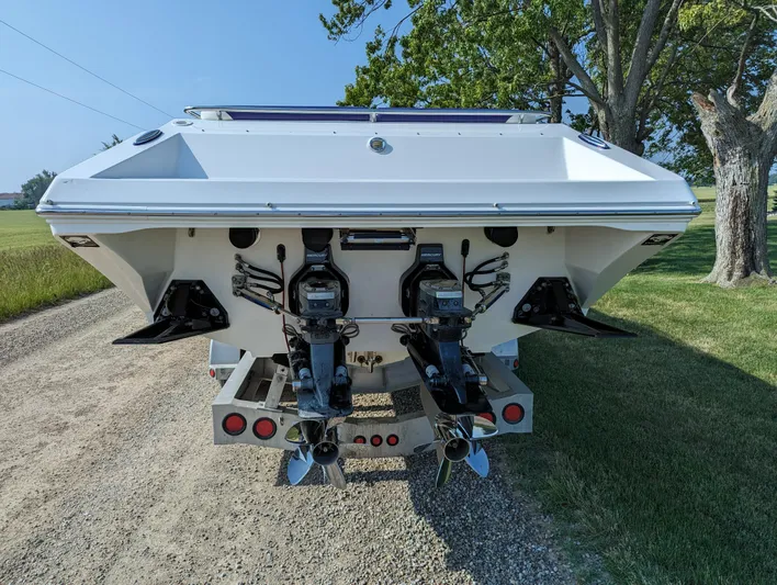  Yacht Photos Pics Rear view of a 2006 Fountain 42 boat on a trailer, showcasing dual outboard motors.