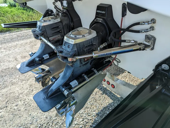  Yacht Photos Pics Twin Mercury outboard engines on a 2006 Fountain 42 boat, parked on gravel.