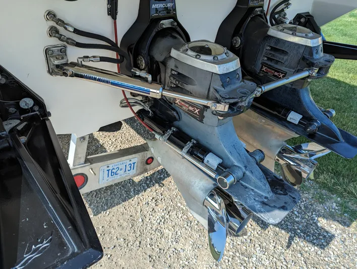  Yacht Photos Pics Twin Mercury outboard engines on a 2006 Fountain 42 boat, parked on gravel.