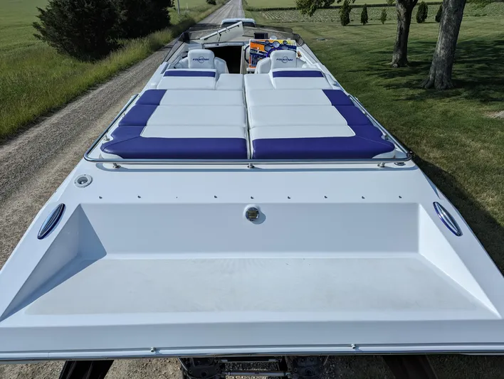  Yacht Photos Pics 2006 Fountain 42 boat with white and blue seating on a rural road.