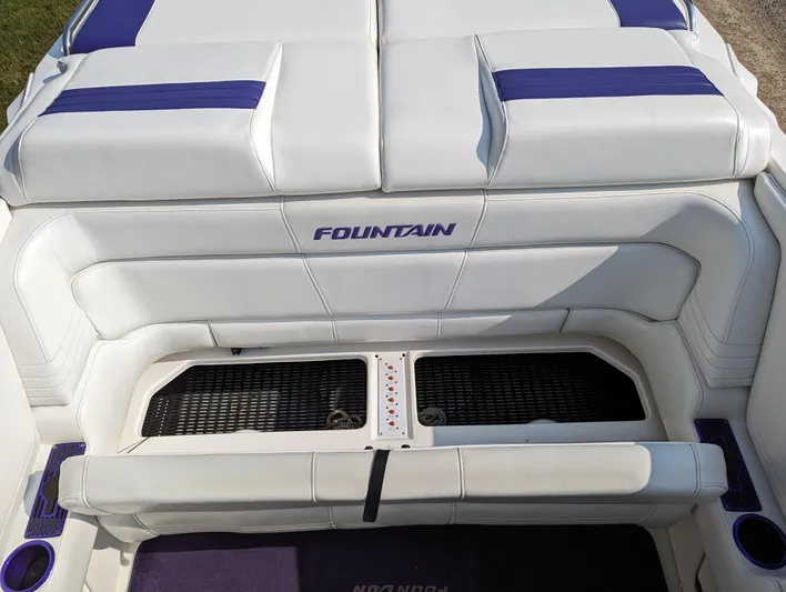  Yacht Photos Pics 2006 Fountain 42 boat interior with white and blue seating.