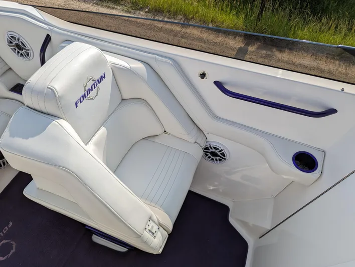  Yacht Photos Pics White leather boat seat in a 2006 Fountain 42, featuring logo and speaker.